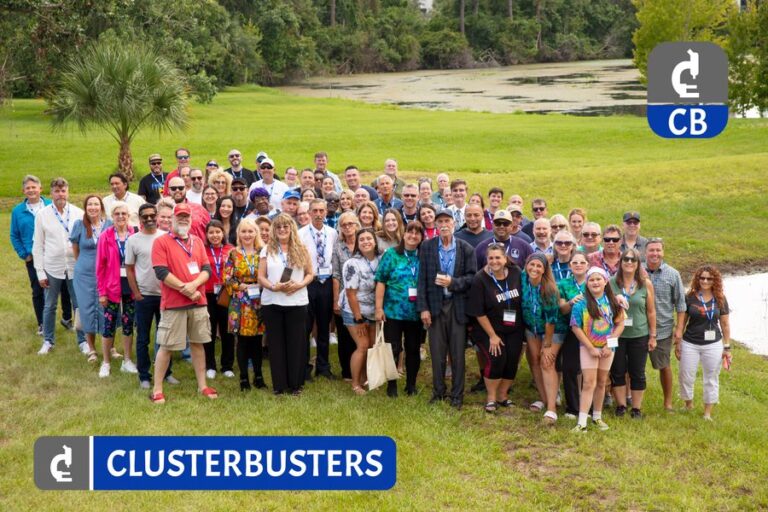 Clusterbusters conference attendees gathered for a group photo outdoors.